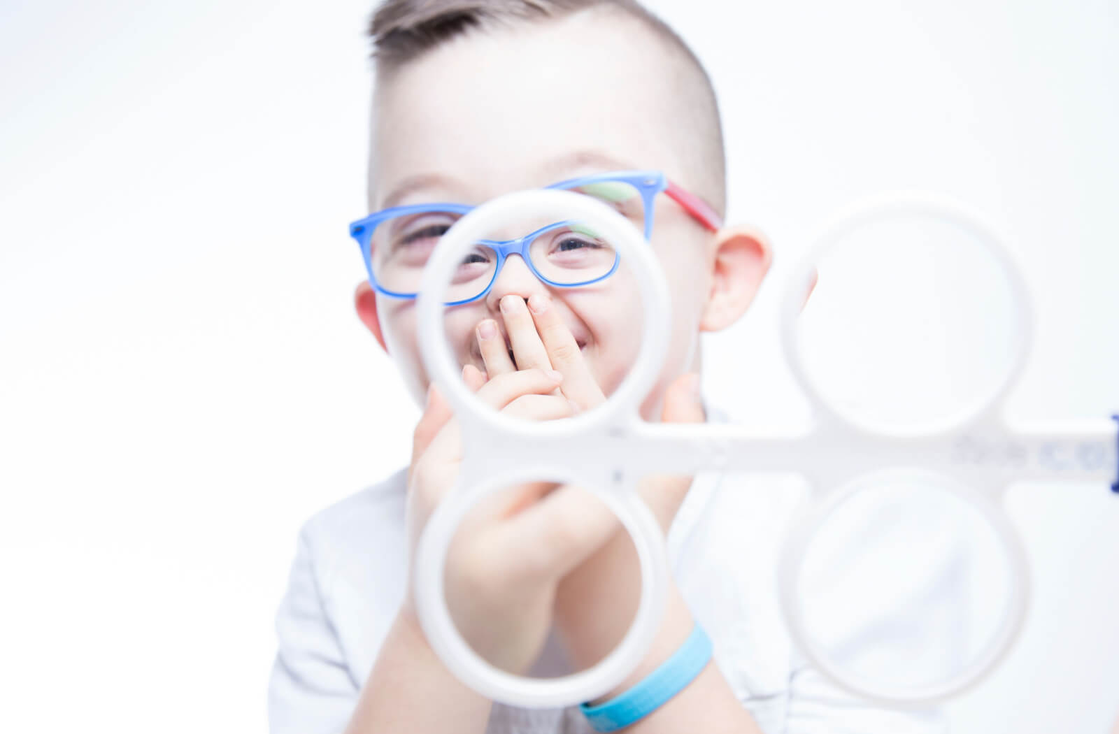 a child laughs while doing vision therapy