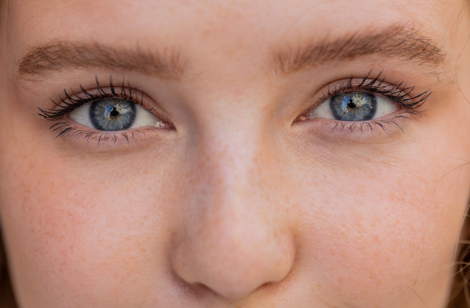 A close up photo of a person with blue eyes.